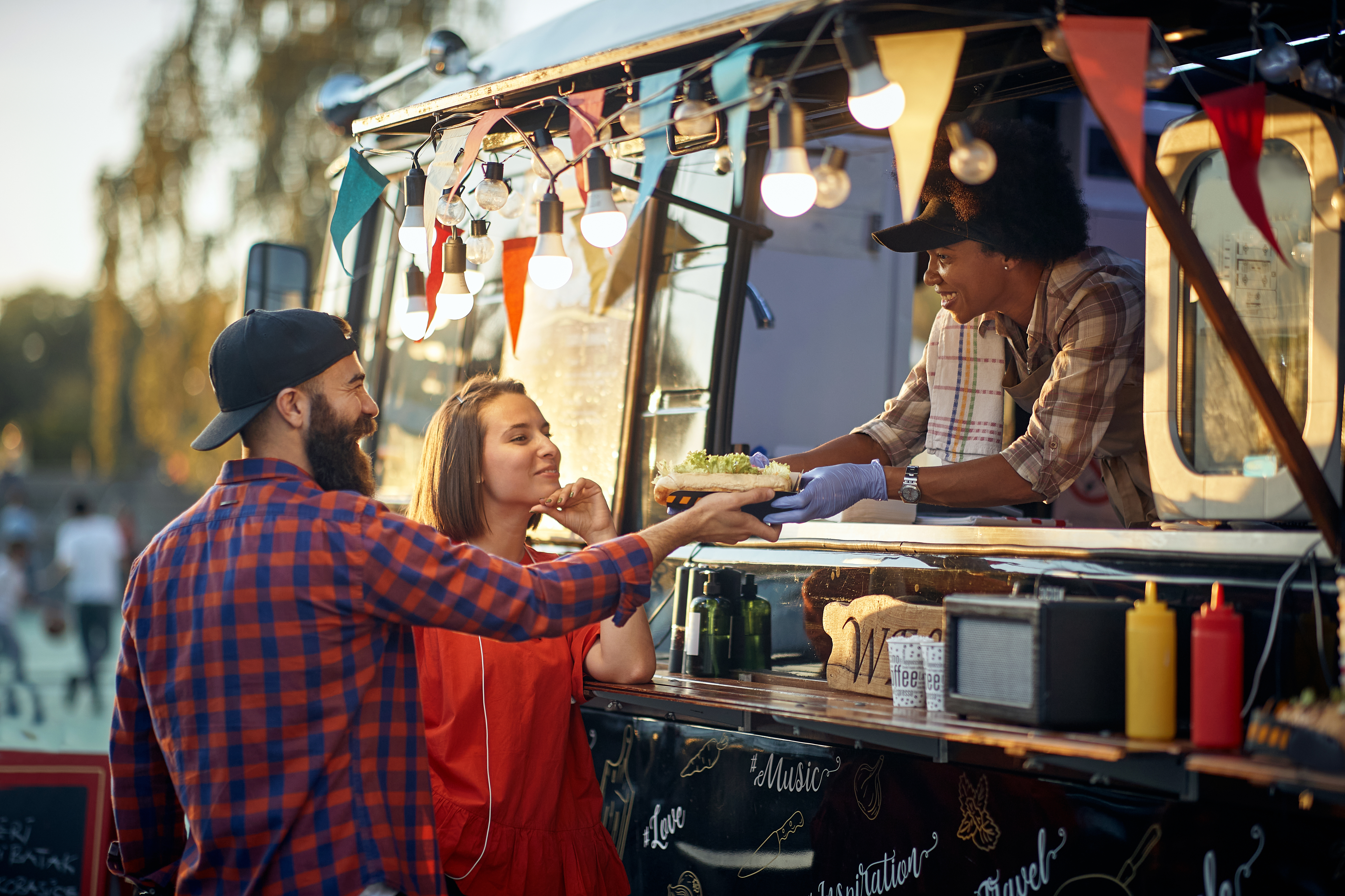 Food truck serves meal to two patrons