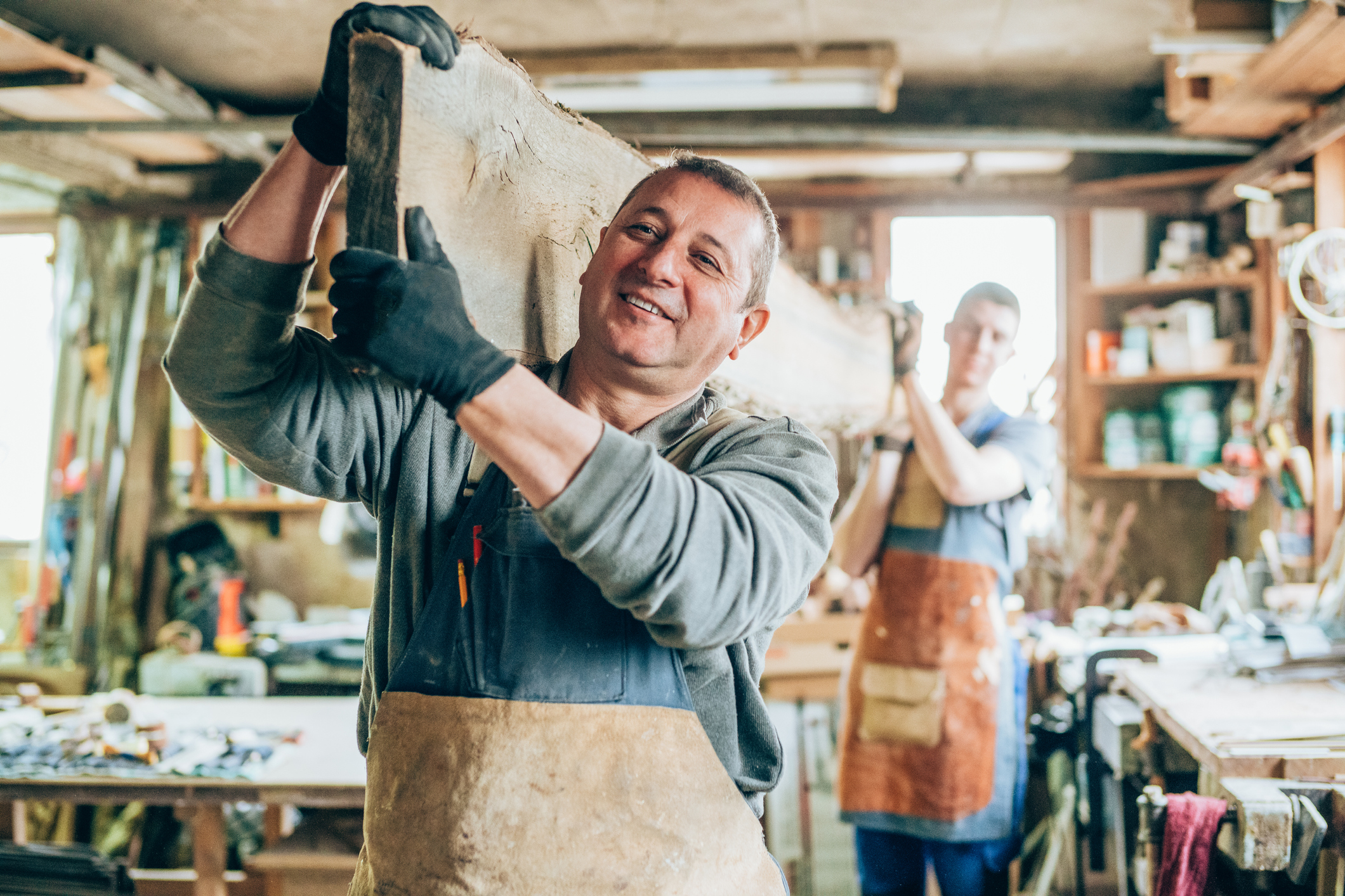 Woodworkers carrying lumber