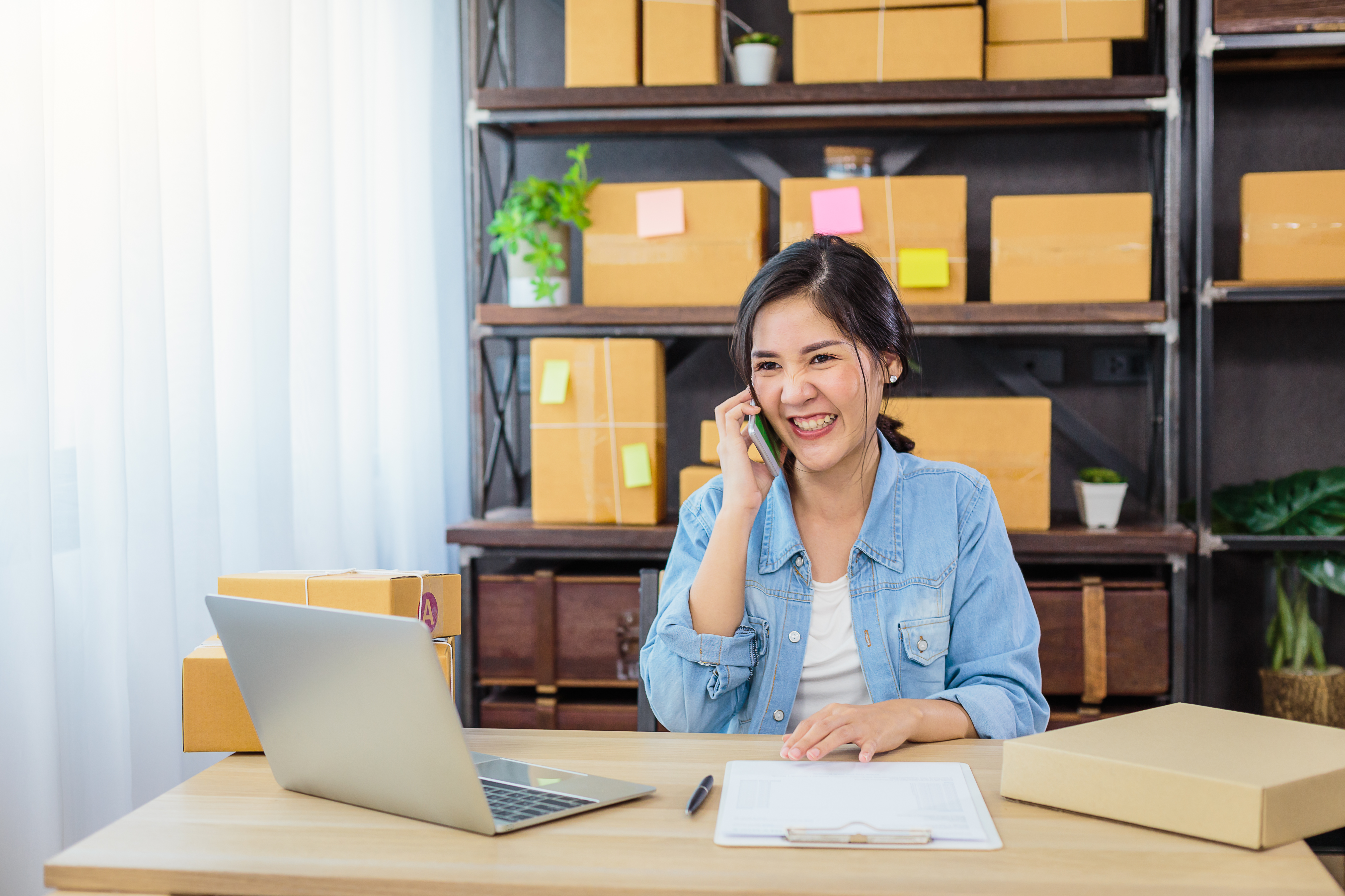 Retail business owner on phone with customer